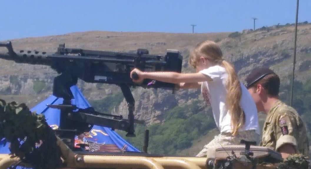 Small child handles an artillery piece, Llandudno 2018