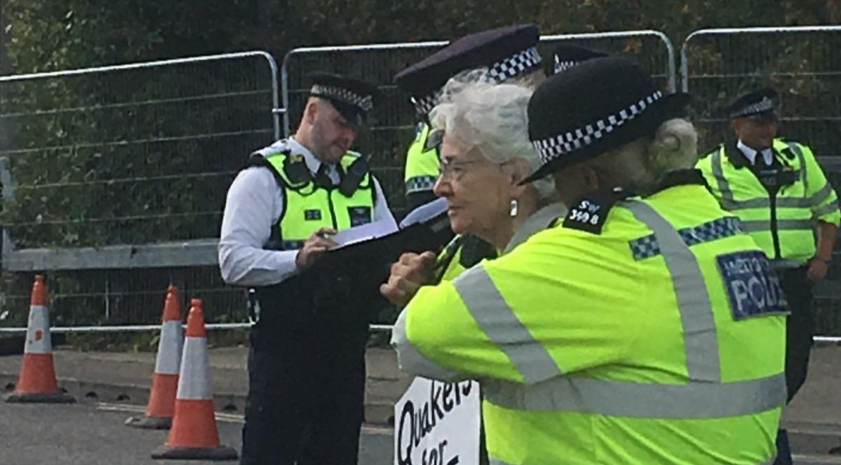 Older Quaker being arrested at DSEI