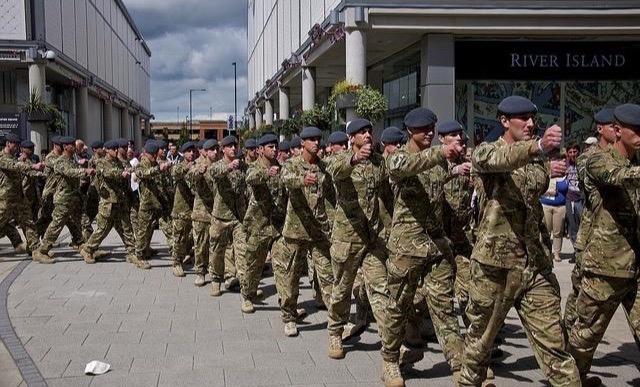 UK troops marching through the street on Armed Forces Day